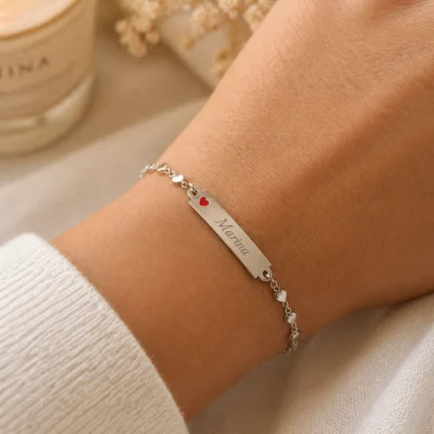 Pulsera de corazones personalizada con placa grabada puesta en muñeca